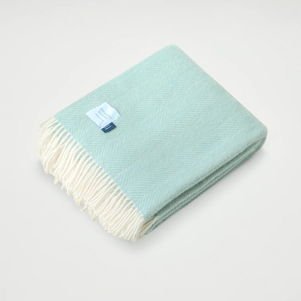 Indulge in luxury with our herringbone throw, featuring a delicate two-toned coastal color palette weave. The texture evokes depth and sophistication, in carefully-selected calming color combinations. This ultra-soft blanket offers satisfying warmth and a tasseled edge to complete the elegant look. This throw qualifies for one blanket to be donated to someone in need.