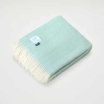 Indulge in luxury with our herringbone throw, featuring a delicate two-toned coastal color palette weave. The texture evokes depth and sophistication, in carefully-selected calming color combinations. This ultra-soft blanket offers satisfying warmth and a tasseled edge to complete the elegant look. This throw qualifies for one blanket to be donated to someone in need.